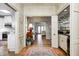 Inviting foyer with hardwood floors leading to the kitchen, living room, and wet bar at 7943 Beaumont Green East Dr, Indianapolis, IN 46250