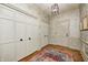 Elegant foyer features hardwood floors, decorative wallpaper, and ample closet space at 7943 Beaumont Green East Dr, Indianapolis, IN 46250
