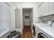 Convenient laundry room with modern appliances and built in storage, located near additional rooms at 7943 Beaumont Green East Dr, Indianapolis, IN 46250