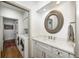 Laundry room with modern appliances, wooden floors, and ample counter space at 7943 Beaumont Green East Dr, Indianapolis, IN 46250
