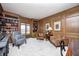 Cozy living room with wooden paneling, built-in bookshelves, and plush seating at 7943 Beaumont Green East Dr, Indianapolis, IN 46250