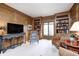 Bright living room with wooden paneling, built-in bookshelves, and plush seating at 7943 Beaumont Green East Dr, Indianapolis, IN 46250