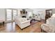 Bright living room with hardwood floors, fireplace, and access to an outdoor patio at 7943 Beaumont Green East Dr, Indianapolis, IN 46250