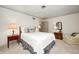 Bedroom featuring a queen bed, and two side tables and a sitting chair at 7943 Beaumont Green East Dr, Indianapolis, IN 46250