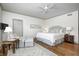 Tranquil main bedroom with hardwood floors, a ceiling fan, and neutral decor at 7943 Beaumont Green East Dr, Indianapolis, IN 46250