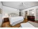 Spacious main bedroom with en-suite bathroom, wood floors, and stylish furnishings at 7943 Beaumont Green East Dr, Indianapolis, IN 46250
