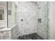 Close-up of the glass enclosed shower with decorative tile surround and black tile floor at 7943 Beaumont Green East Dr, Indianapolis, IN 46250