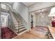 Classic staircase with wooden banister, leading to the upper level of the home at 7943 Beaumont Green East Dr, Indianapolis, IN 46250