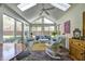 Bright sunroom with brick floor, wicker seating, and lots of natural light at 7943 Beaumont Green East Dr, Indianapolis, IN 46250