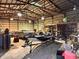 Spacious barn interior with high ceilings, ideal for storing equipment and supplies with a boat at 8089 W Old State Road 67, Paragon, IN 46166