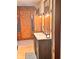 Bathroom with wood paneled wall and cabinets, and modern vessel sink at 8089 W Old State Road 67, Paragon, IN 46166