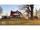 Charming farmhouse featuring a red roof, brick foundation, and a welcoming front porch at 8089 W Old State Road 67, Paragon, IN 46166