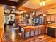 Open kitchen and dining area with wooden cabinets, island cooktop, and pot rack at 8089 W Old State Road 67, Paragon, IN 46166