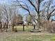 Large backyard features mature trees, a bench, and a traditional fence at 810 S 400 W, Bargersville, IN 46106