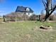 Backyard with a traditional fence, fire pit, house, and a grassy area at 810 S 400 W, Bargersville, IN 46106