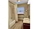 Bathroom with bathtub, sink, toilet, carpet, and natural light from windows at 810 S 400 W, Bargersville, IN 46106