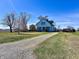 Traditional two story home with a long gravel driveway and lush green lawn at 810 S 400 W, Bargersville, IN 46106
