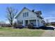 Charming two-story home with covered porch and mature landscaping sits under a clear blue sky at 810 S 400 W, Bargersville, IN 46106