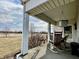View of the front porch with rocking chairs and hanging planter overlooking open space at 810 S 400 W, Bargersville, IN 46106