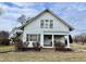 Charming white two-story home featuring a covered porch, symmetrical design, and mature shrubs in the front yard at 810 S 400 W, Bargersville, IN 46106