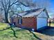 Detached garage with a red brick exterior, a white garage door, and a side door at 810 S 400 W, Bargersville, IN 46106