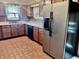 Well-appointed kitchen featuring ample cabinetry, black appliances, and tile flooring at 810 S 400 W, Bargersville, IN 46106