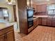 Kitchen featuring wood cabinets, tile floor, and modern appliances at 810 S 400 W, Bargersville, IN 46106