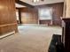 Cozy living room featuring warm wood paneling, neutral carpeting, and lots of natural light at 810 S 400 W, Bargersville, IN 46106