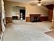 Spacious living room showcasing a classic brick fireplace and arched doorway to another room at 810 S 400 W, Bargersville, IN 46106