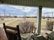 Relaxing covered porch with rocking chairs and a view of the expansive yard and a gravel driveway at 810 S 400 W, Bargersville, IN 46106