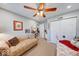 Bedroom with neutral carpeting, a ceiling fan, daybed, and closet with a white bi-fold door at 8318 Golden Ridge Ln, Indianapolis, IN 46237