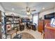 Bedroom with a ceiling fan, desk with office chair, bookcase, and dresser; carpeted floor and natural light at 8318 Golden Ridge Ln, Indianapolis, IN 46237