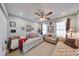 Bedroom featuring a daybed with colorful pillows, bench, ceiling fan, large windows and neutral colored carpet at 8318 Golden Ridge Ln, Indianapolis, IN 46237