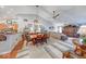 Bright open-concept dining area flowing into the living room features modern lighting and decor at 8318 Golden Ridge Ln, Indianapolis, IN 46237
