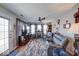 Cozy living room with a fireplace, ceiling fan, and comfortable seating at 8318 Golden Ridge Ln, Indianapolis, IN 46237
