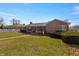 Brick house featuring a covered porch, mature bushes, and a grassy front lawn at 847 Churchman Ave, Beech Grove, IN 46107