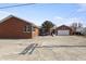 Rear exterior view with brick facade and large parking pad at 847 Churchman Ave, Beech Grove, IN 46107