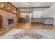 Inviting living room featuring wood floors, brick fireplace, and comfortable seating at 847 Churchman Ave, Beech Grove, IN 46107