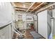 Unfinished basement area with exposed piping, a refrigerator, and basic storage solutions at 8759 Buttonbush Cir, Plainfield, IN 46168