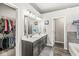 Bathroom featuring double sinks, modern fixtures, and separate walk-in closet at 8759 Buttonbush Cir, Plainfield, IN 46168