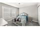 Bedroom with plush carpet, window, and stylish gray furnishings at 8759 Buttonbush Cir, Plainfield, IN 46168
