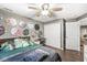 Bedroom with ceiling fan, closet, and drum decor at 8759 Buttonbush Cir, Plainfield, IN 46168