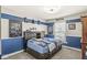 Bedroom features sporty decor and a large, inviting bed at 8759 Buttonbush Cir, Plainfield, IN 46168