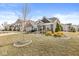 Beautiful suburban home featuring stone accents, green shutters, landscaped yard and mature trees at 8759 Buttonbush Cir, Plainfield, IN 46168