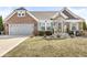 Charming brick and stone home with a two-car garage, manicured lawn, and inviting front entrance at 8759 Buttonbush Cir, Plainfield, IN 46168
