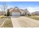 Lovely brick home with stone accents, an attached garage, and a concrete driveway at 8759 Buttonbush Cir, Plainfield, IN 46168