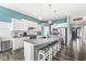 Open kitchen featuring an island with seating, stainless steel appliances and a view of the front door at 8759 Buttonbush Cir, Plainfield, IN 46168
