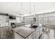 Open concept layout featuring a kitchen island with seating, and a cozy living room with a fireplace at 8759 Buttonbush Cir, Plainfield, IN 46168