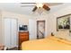 Bedroom with ceiling fan, wood-look floors, closet, TV, and dresser combination at 915 Prestwick Dr # D, Indianapolis, IN 46214