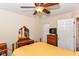Relaxing bedroom with a ceiling fan, dresser, TV, and white closet doors at 915 Prestwick Dr # D, Indianapolis, IN 46214